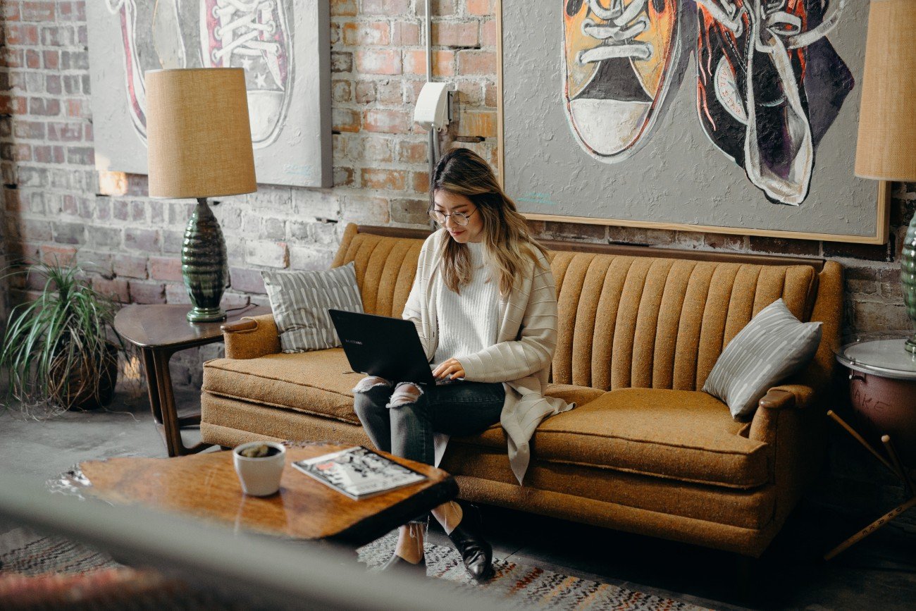Events: Woman with laptop on couch